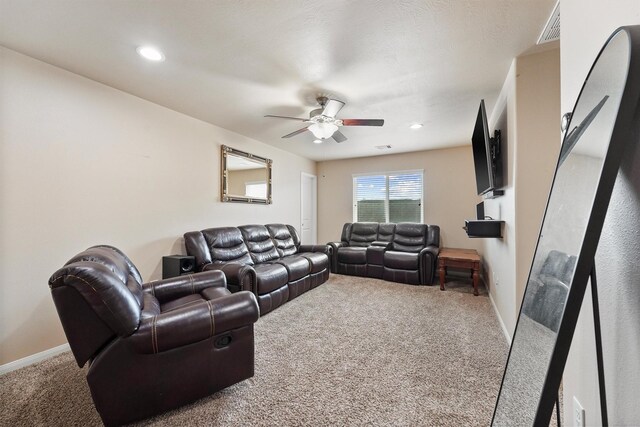 living area featuring visible vents, baseboards, carpet, recessed lighting, and a ceiling fan