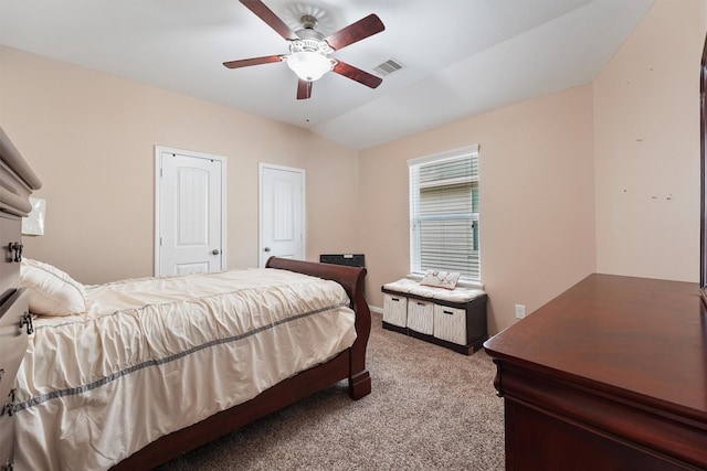 bedroom with visible vents, ceiling fan, lofted ceiling, and carpet floors