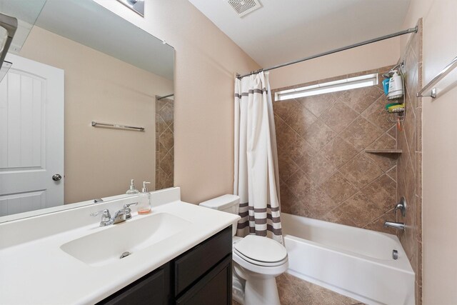 full bathroom with visible vents, vanity, toilet, and shower / tub combo