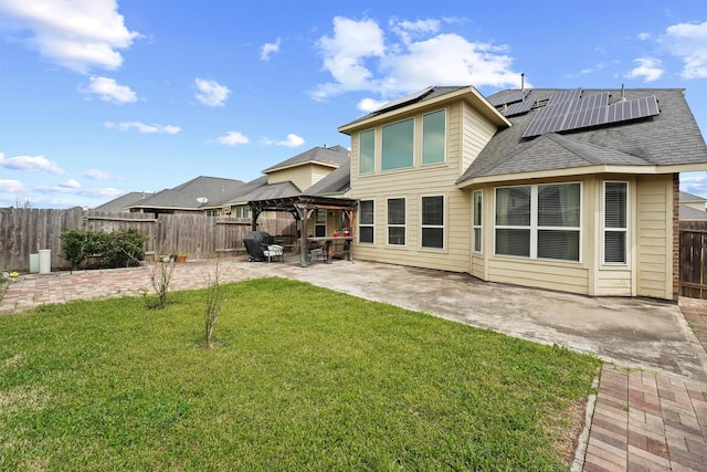 back of property with a gazebo, a yard, a patio, and a fenced backyard