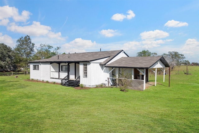 back of house with a lawn