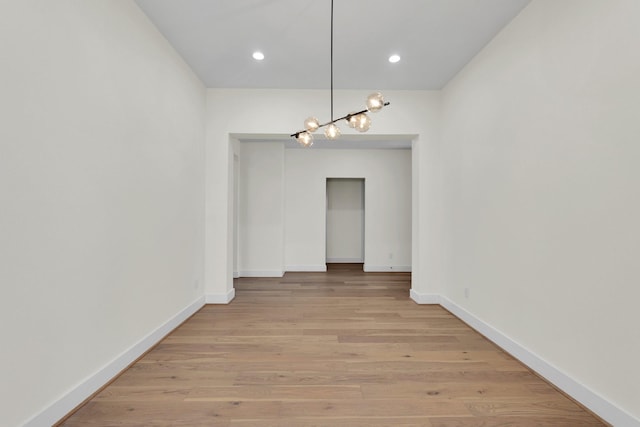 unfurnished dining area featuring recessed lighting, light wood-style flooring, and baseboards