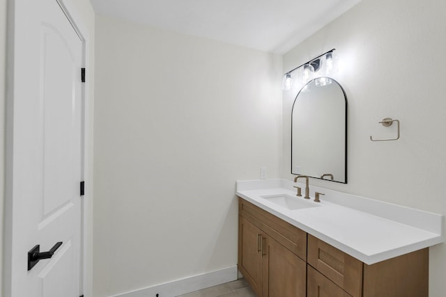 bathroom with tile patterned floors, baseboards, and vanity