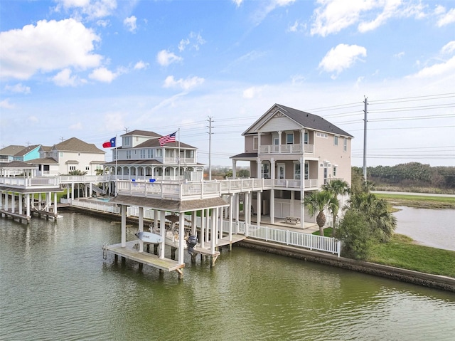 view of dock featuring boat lift, a balcony, and a water view