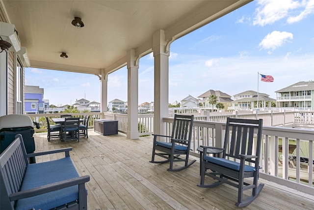 wooden deck with area for grilling and a residential view