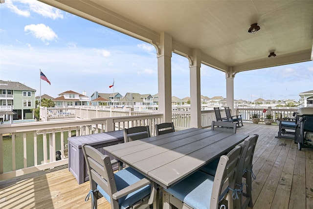 wooden deck with outdoor dining space and a residential view