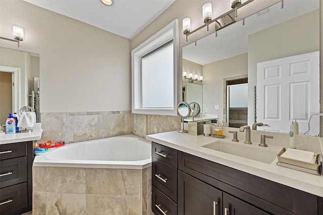 bathroom with vanity and a garden tub