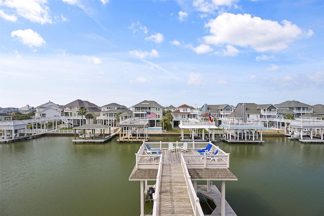 dock area with a residential view and a water view