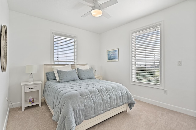 carpeted bedroom with baseboards and a ceiling fan