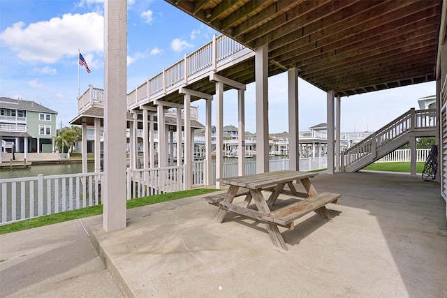 view of patio / terrace with stairway and a water view