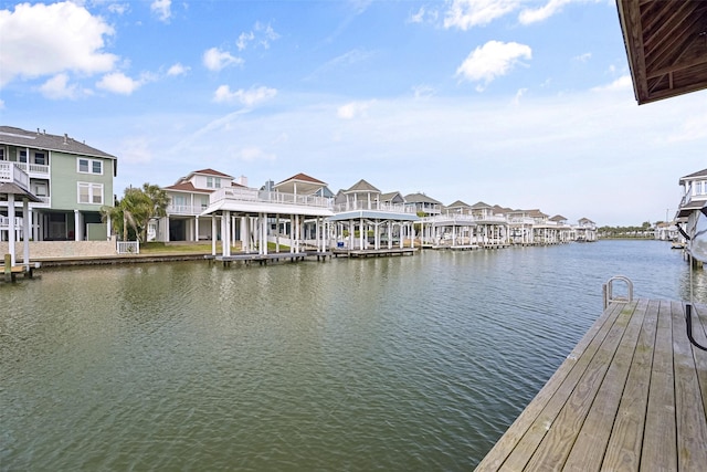 dock area with a residential view and a water view