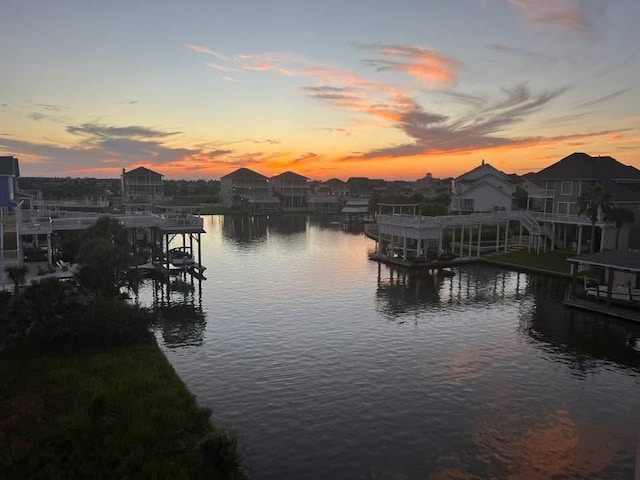dock area with a water view and boat lift