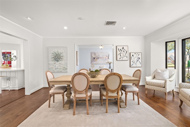 dining room featuring recessed lighting, wood finished floors, visible vents, and ornamental molding