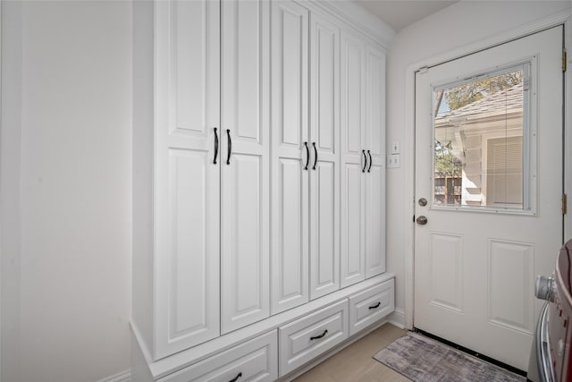 doorway to outside featuring light tile patterned flooring