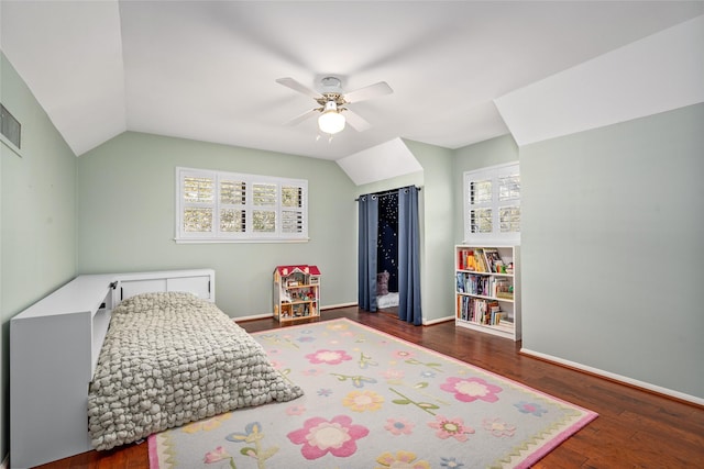 bedroom featuring ceiling fan, baseboards, lofted ceiling, and wood finished floors