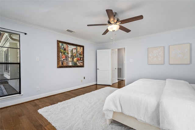 bedroom featuring visible vents, dark wood-type flooring, ceiling fan, baseboards, and ornamental molding