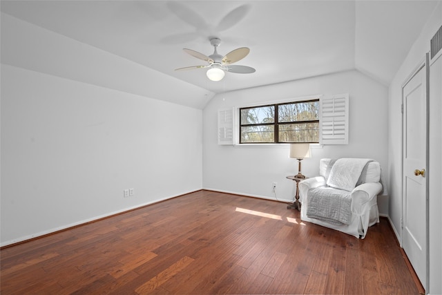 unfurnished room with hardwood / wood-style flooring, a ceiling fan, baseboards, and vaulted ceiling