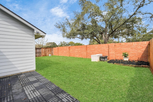 view of yard with a fenced backyard