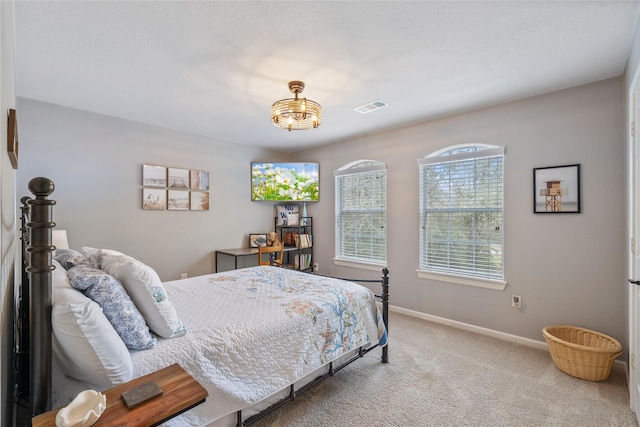 carpeted bedroom featuring visible vents and baseboards