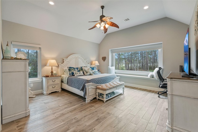 bedroom with light wood-type flooring, lofted ceiling, visible vents, and baseboards