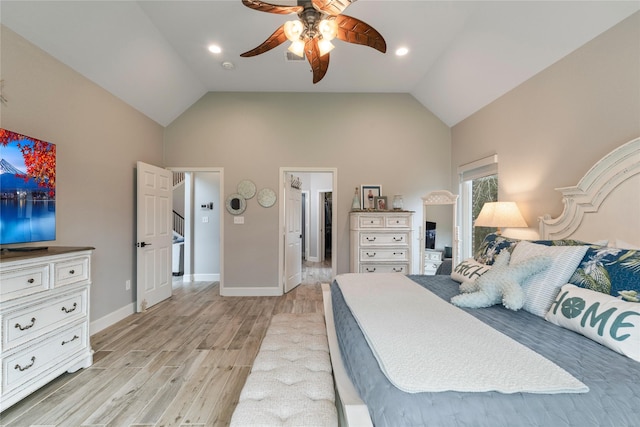 bedroom with light wood-style floors, vaulted ceiling, baseboards, and ceiling fan