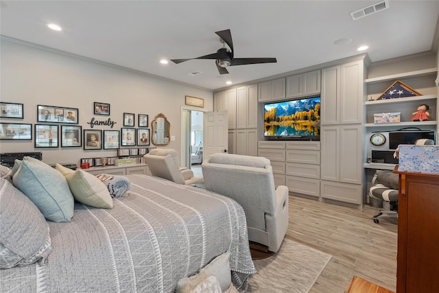 bedroom with light wood-type flooring, visible vents, crown molding, and recessed lighting