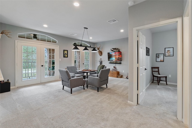 dining room featuring french doors, visible vents, and light carpet