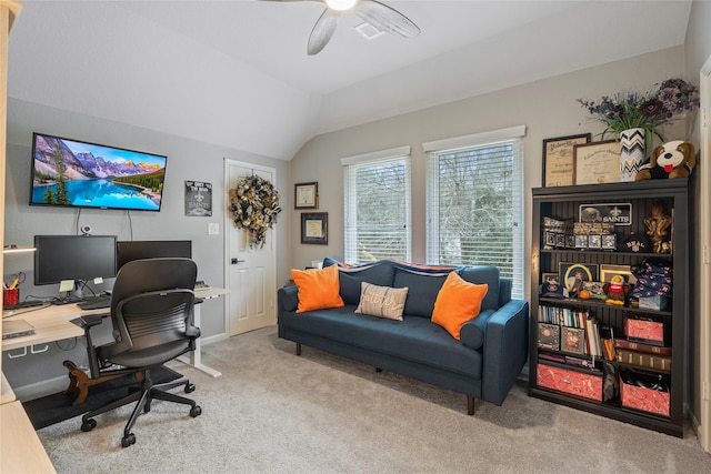 office space featuring lofted ceiling, visible vents, a ceiling fan, and carpet flooring