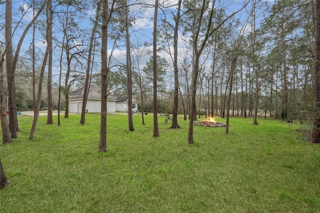 view of yard with an outdoor fire pit