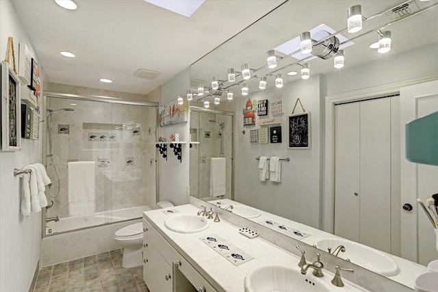 bathroom with tiled shower / bath, a sink, and toilet