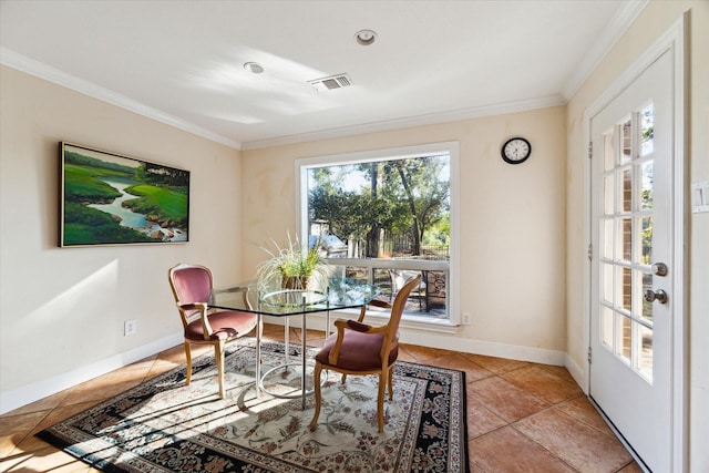 dining space featuring baseboards, light tile patterned flooring, visible vents, and crown molding