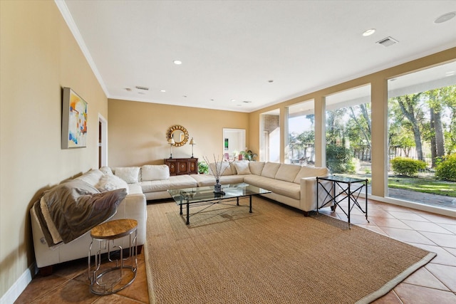 living area with crown molding, tile patterned flooring, visible vents, and plenty of natural light