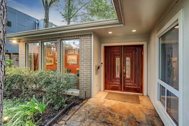 doorway to property featuring brick siding