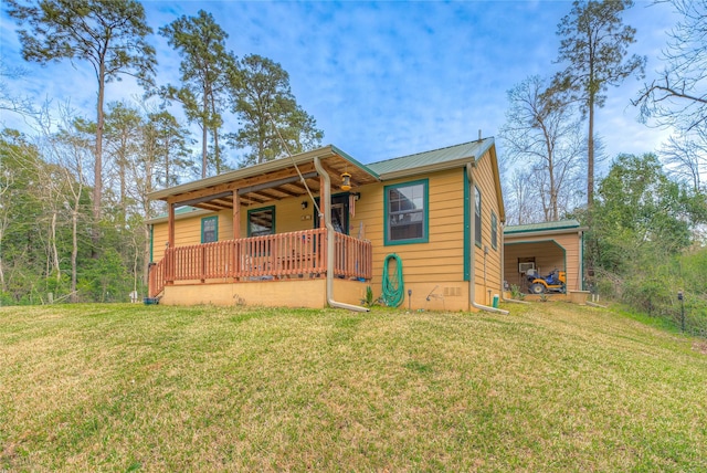 view of front of house featuring covered porch, metal roof, and a front yard