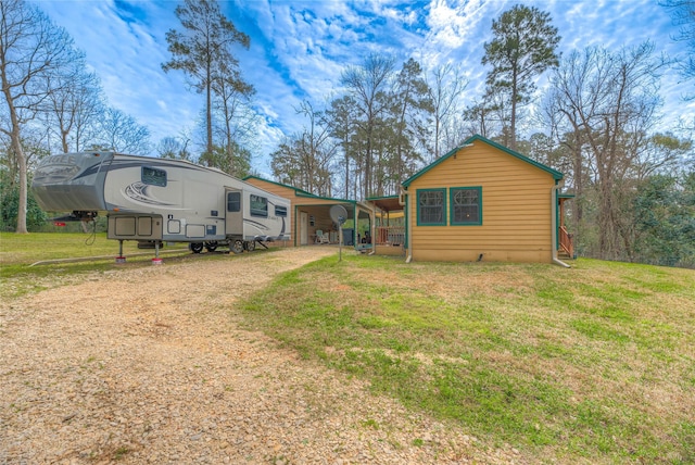 exterior space with driveway and a front yard