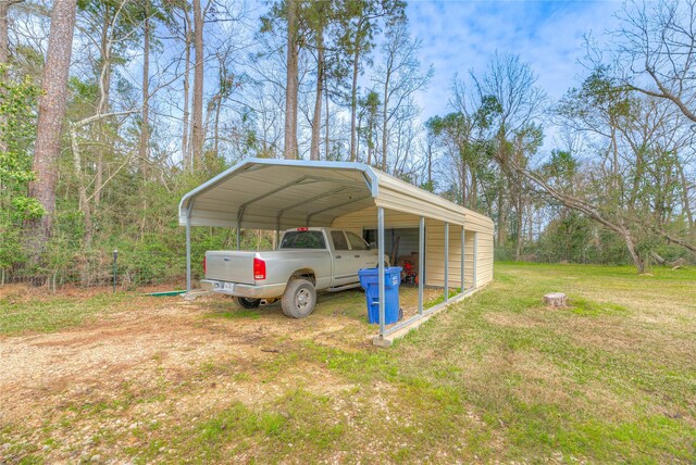 view of vehicle parking featuring dirt driveway and a carport