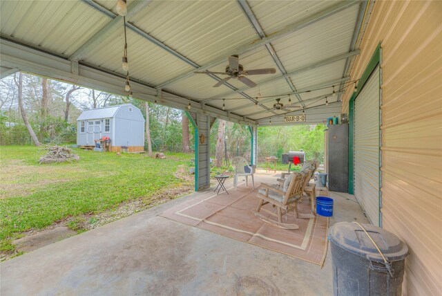 view of patio with an outbuilding, a storage shed, and a ceiling fan