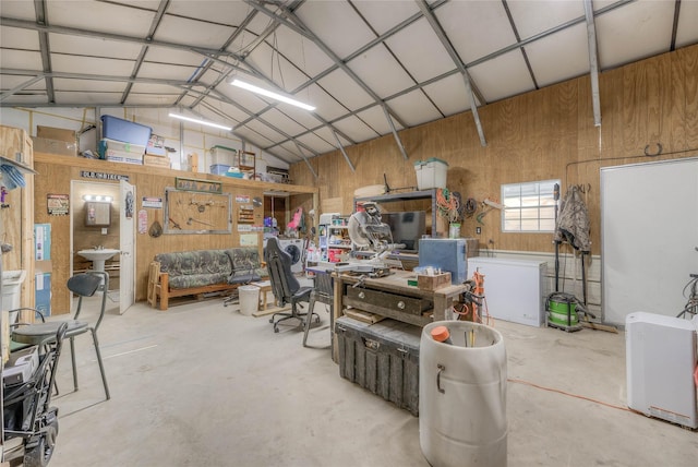 garage with a workshop area and metal wall