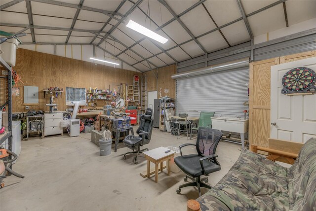 garage with a workshop area and metal wall