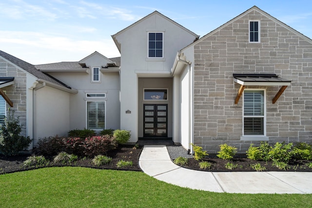 view of front of house with stone siding, stucco siding, and roof with shingles