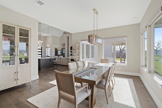 dining area with a wealth of natural light, visible vents, baseboards, and wood finished floors