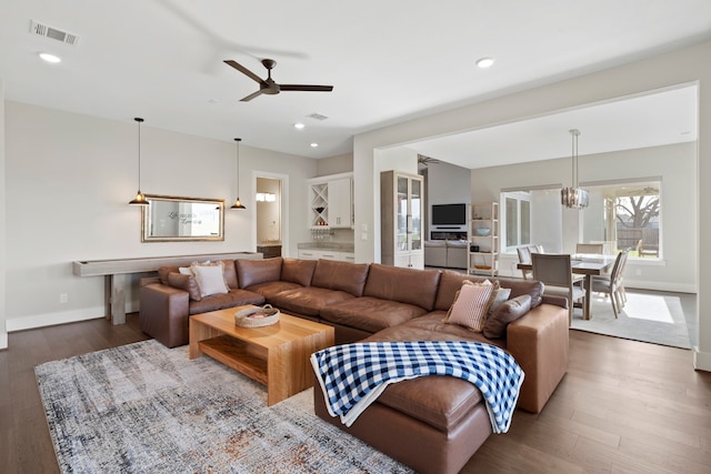 living room with visible vents, a ceiling fan, wood finished floors, recessed lighting, and baseboards