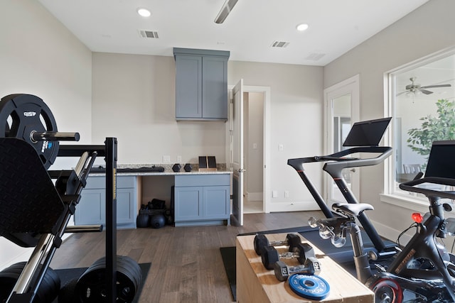 workout area featuring dark wood-style floors, visible vents, recessed lighting, and a ceiling fan