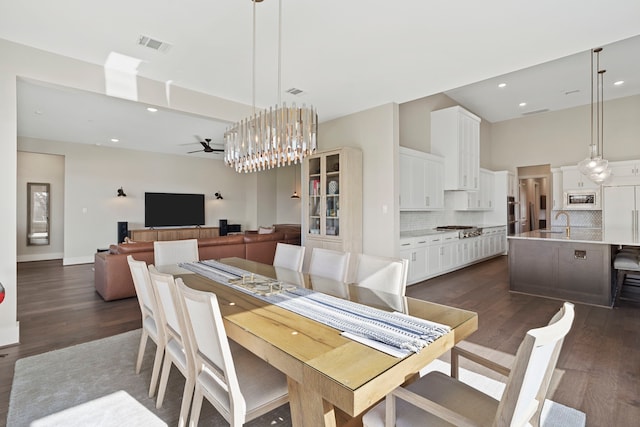 4103 Willowisp Ct, Fulshear, TX 77441 - dining area featuring ceiling fan, dark wood-style floors, a towering ceiling, recessed lighting, and a chandelier