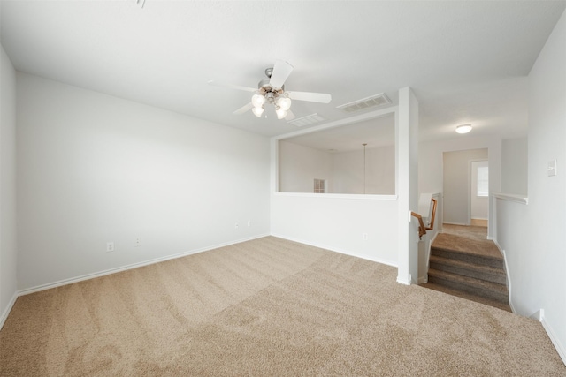 spare room with baseboards, ceiling fan, visible vents, and carpet flooring