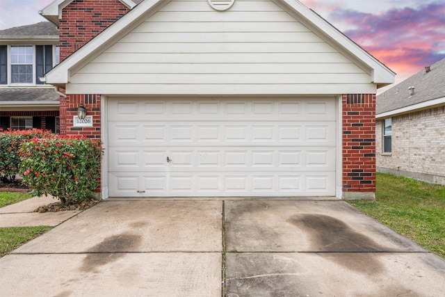 garage at dusk with driveway