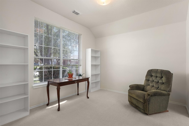 living area featuring vaulted ceiling, carpet flooring, visible vents, and baseboards