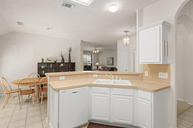 kitchen with visible vents, arched walkways, dishwasher, a peninsula, and a sink