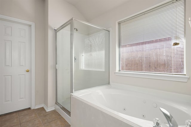 bathroom featuring a shower stall, a tub with jets, and tile patterned floors