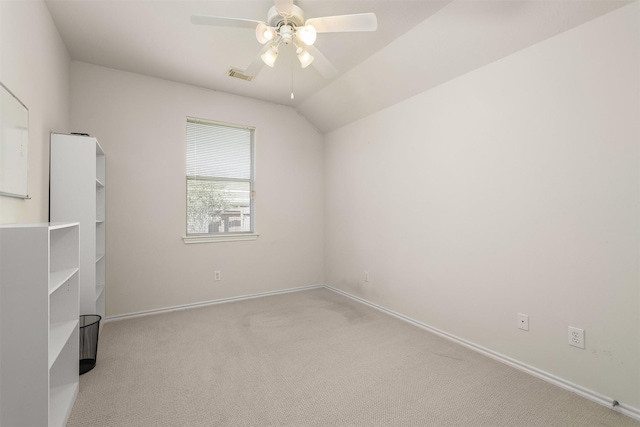 unfurnished room featuring light carpet, visible vents, baseboards, lofted ceiling, and ceiling fan